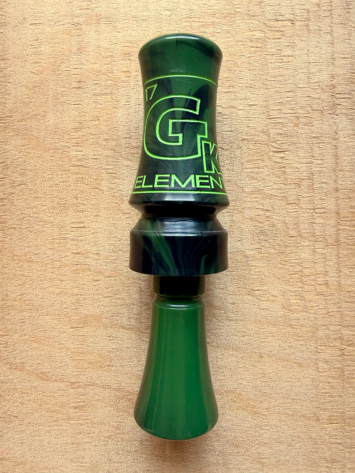 GK Calls Heritage Series Element duck call in Swamp Grass Green, lying on a wood board