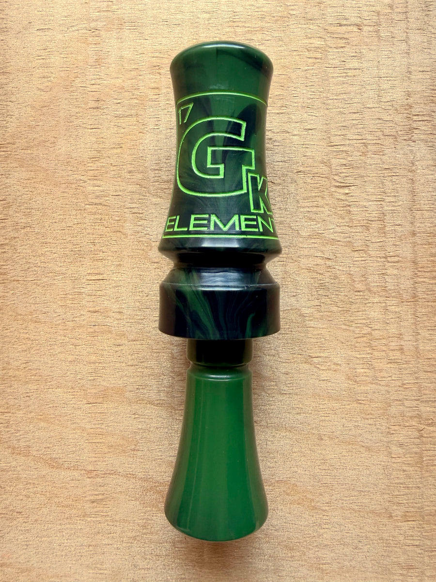 GK Calls Heritage Series Element duck call in Swamp Grass Green, lying on a wood board